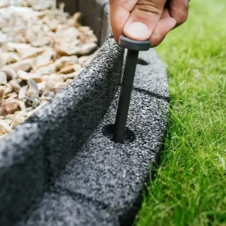 Enviro Blocks edging separating lawn and flower bed.